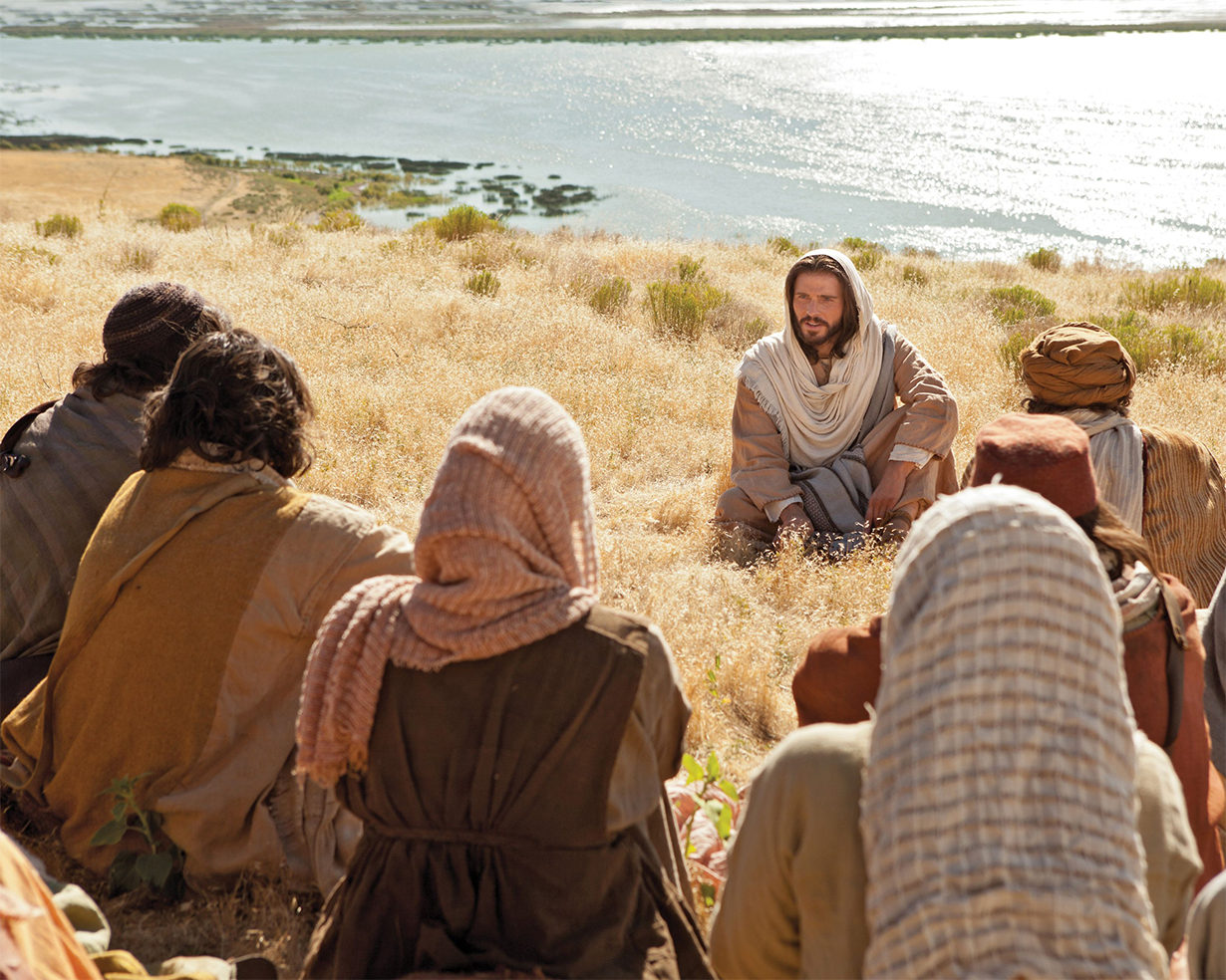 Jesus Christ teaching people in a field of long grass