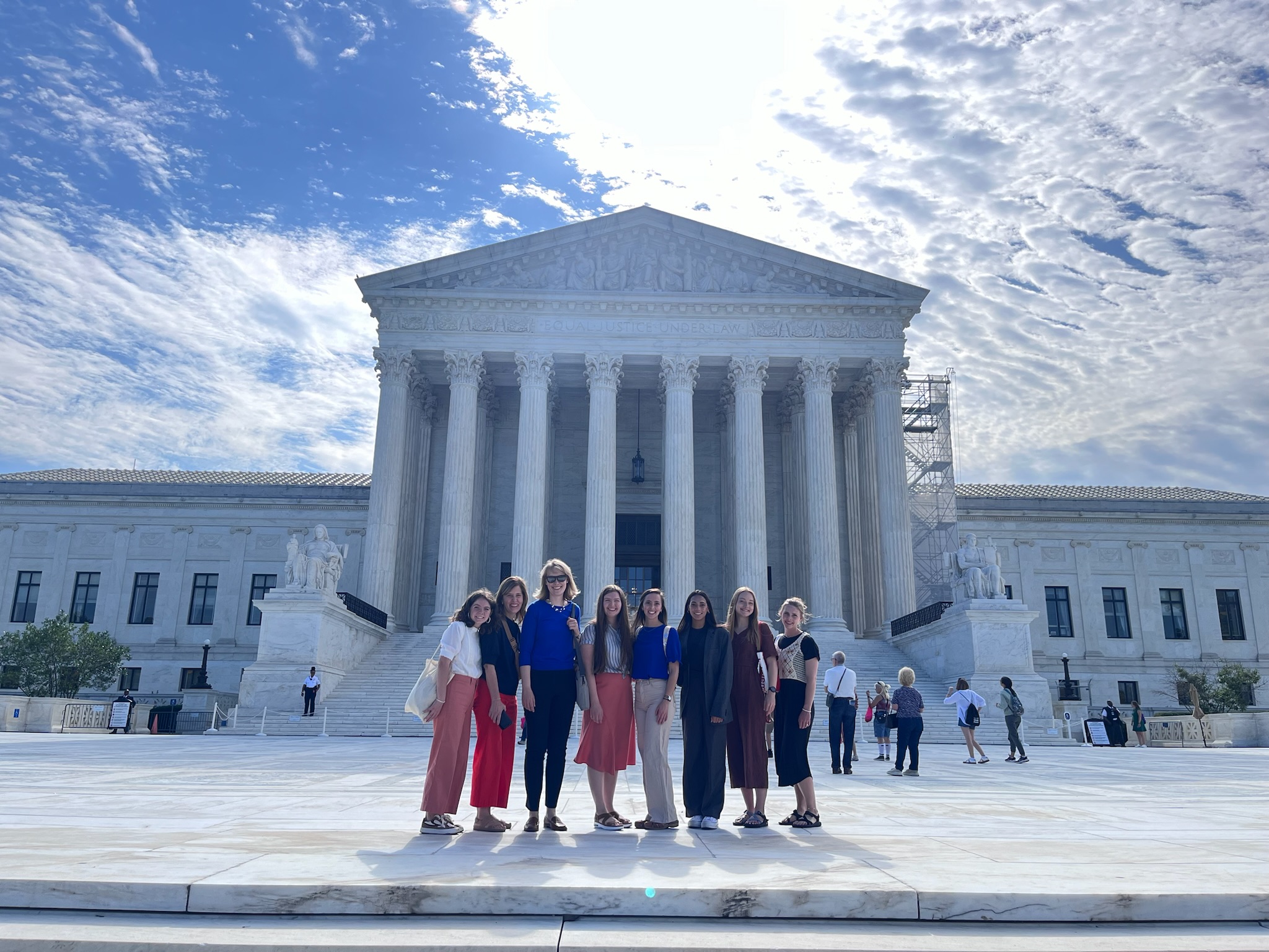 A group of people standing in front of a monument in Washington DC