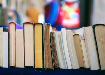 stack of books on a bookshelf