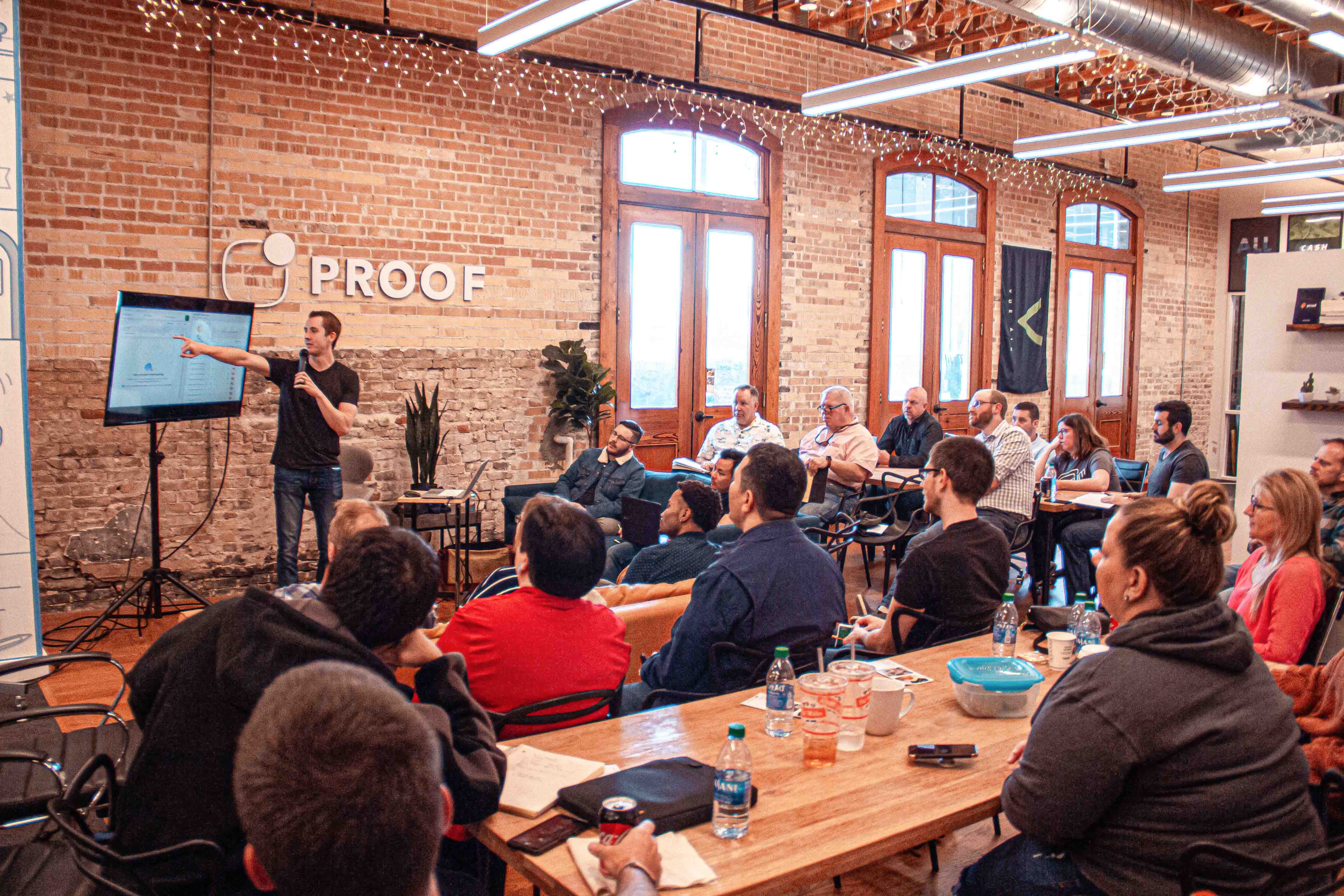group of people watching a man present 