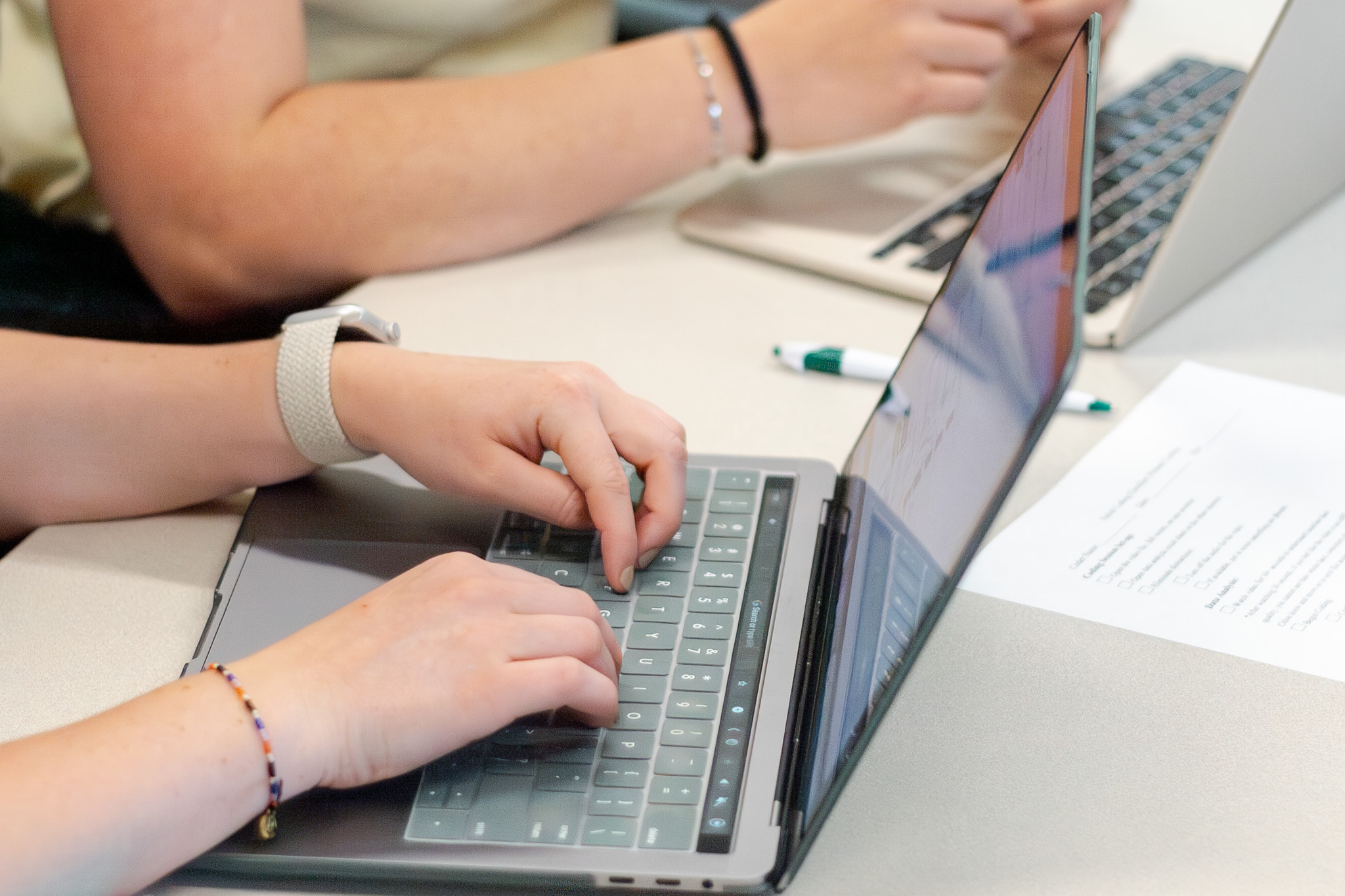 Someone typing at a computer