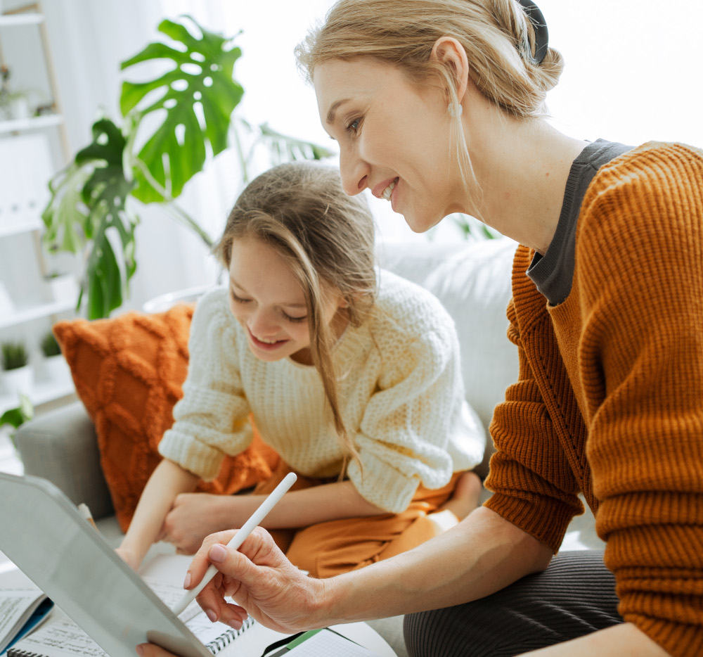 Woman helping kid with homework