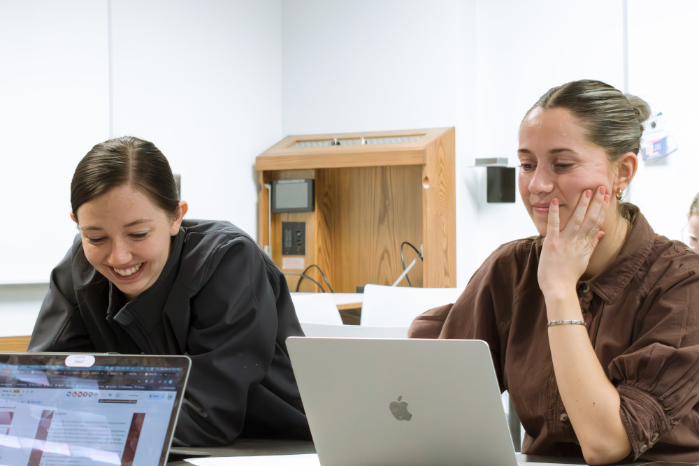 Two women working on laptops