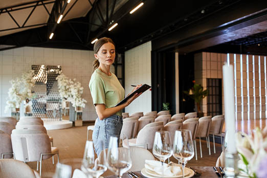woman with a clipboard looking at things on a table