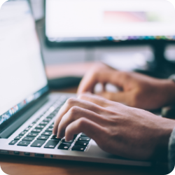 person typing at computer