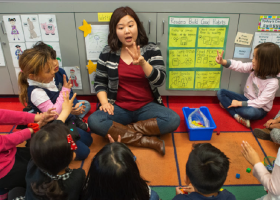 Teacher sitting with her students
