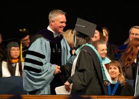 Graduate receiving their diploma