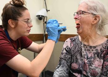 A doctor helping an elderly patient