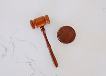 A gavel on white marble