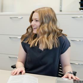 Woman smiling and sitting at table